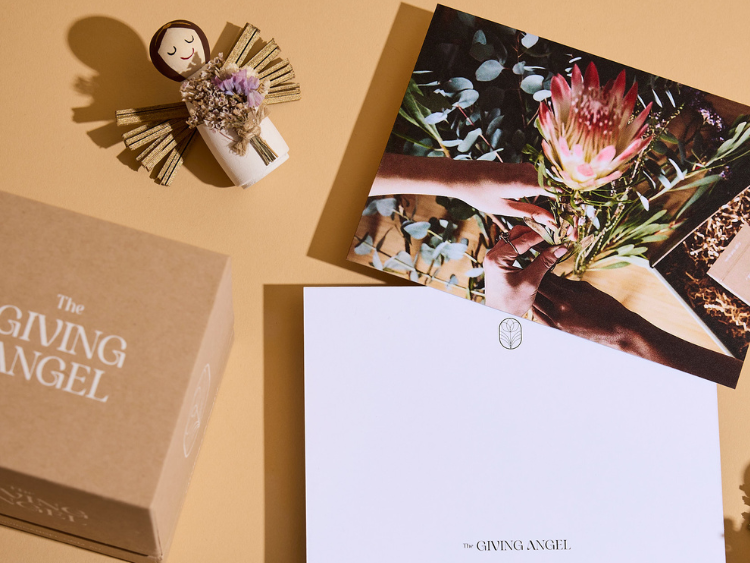 Giving Angel keepsake, gift box and greeting card with flowers, symbolising a thoughtful sympathy and remembrance gift.