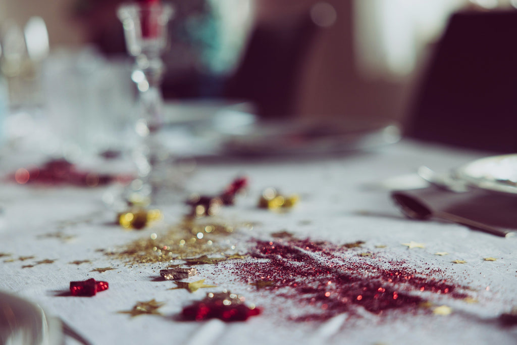 Messy Christmas table with discarded decorations, representing the waste left behind after the festive season.