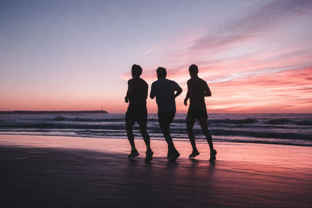 People jogging along the beach at sunset, representing heart health, healthy lifestyles and the prevention research supported by Baker Heart & Diabetes Institute.