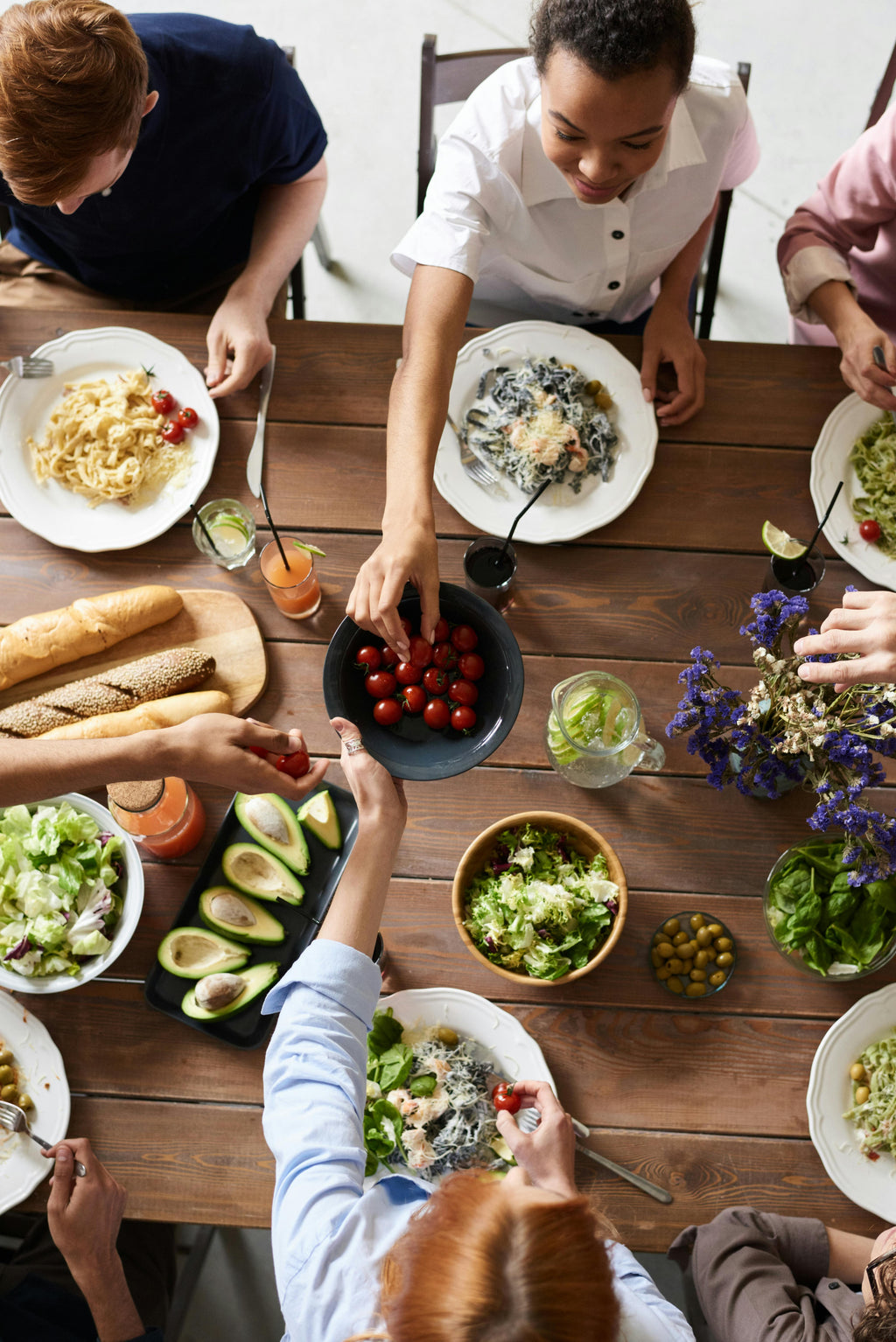Friends sharing a meal together to represent community connection and support.