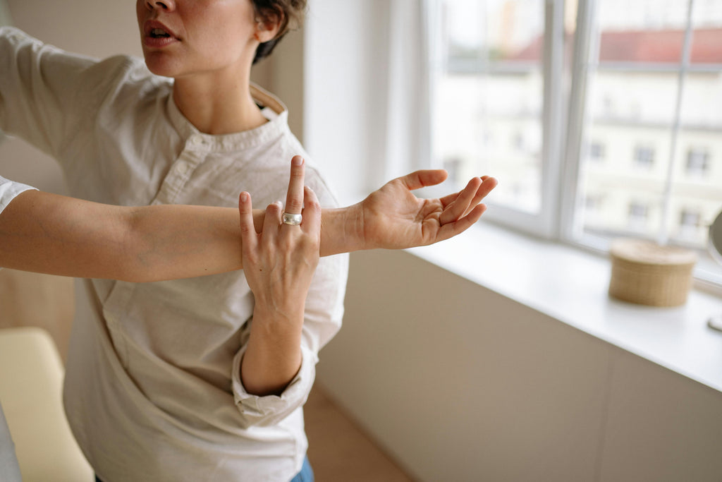 Healthcare professional helping a person with arm rehabilitation after stroke.