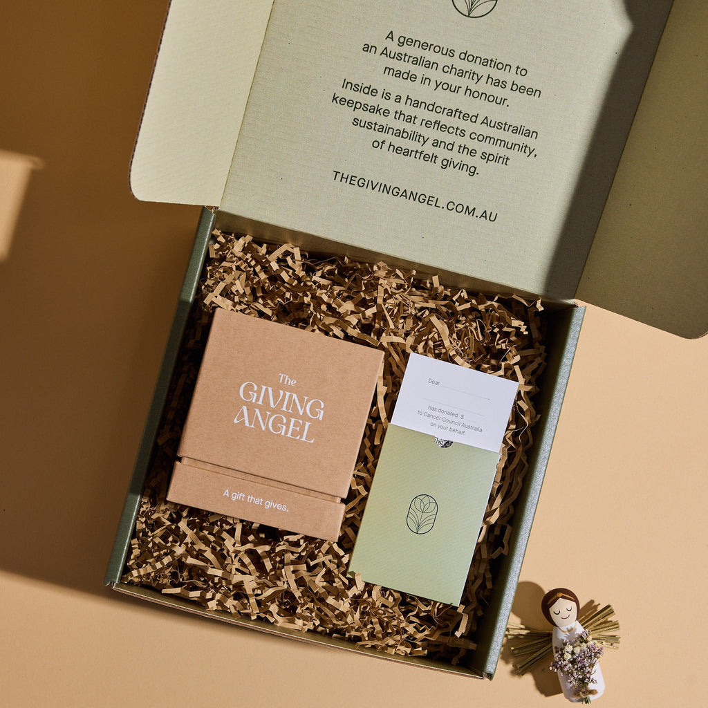The Giving Angel gift box with handcrafted angel keepsake, donation card and sustainable packaging.