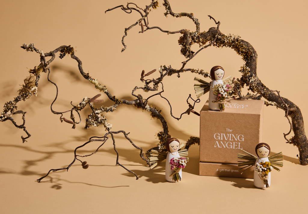 Handcrafted Giving Angel keepsakes displayed with gift box and preserved flower bouquets.